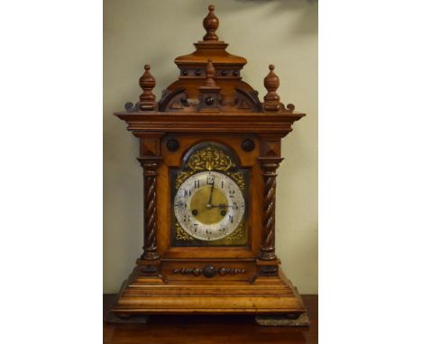 Late 19th/early 20th Century walnut cased architectural style bracket clock, the arch shaped bevelled glazed door flanked by 