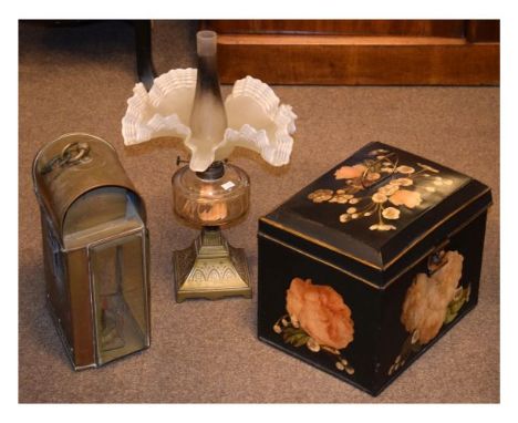 Victorian oil lamp having a clear glass reservoir and standing on a brass base, brass cased lantern and a floral patterned bo