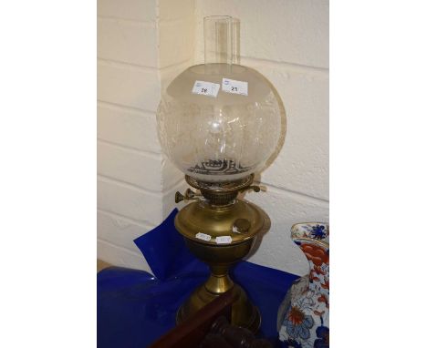 Brass based oil lamp with frosted glass shade