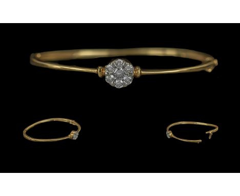 18ct Gold Diamond Set Bangle, the front set with a small cluster of round brilliant cut diamonds.  Gross weight 9.5 grams.