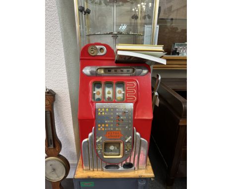 Mills Bell Fruit Machine, in good working order, recently serviced and with bag of coins.  Together with four books on the to