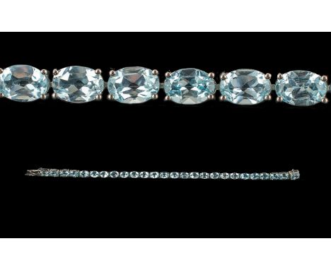 Blue Topaz Tennis Bracelet, oval cut bright, sparkling blue topaz totalling 25cts, set in a single row, in platinum vermeil a