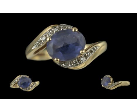 9ct Gold Tanzanite &amp; Diamond Set Dress Ring, the central oval Tanzanite of good colour, set with diamond twist shoulders.
