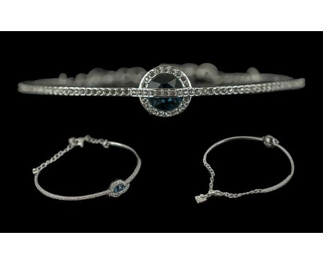Swarovski Bangle, with a circular blue stone surrounded by Swarovski crystals. In original box and outer box.