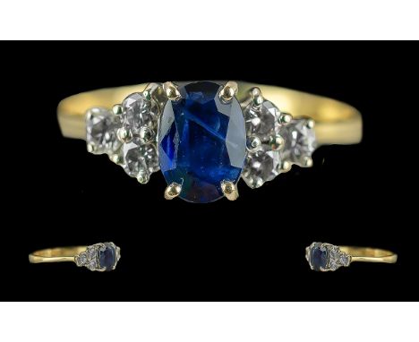 Ladies 18ct Gold Attractive Sapphire and Diamond Set Dress Ring, Marked 18ct to Interior of Shank. The Central Blue Sapphire 