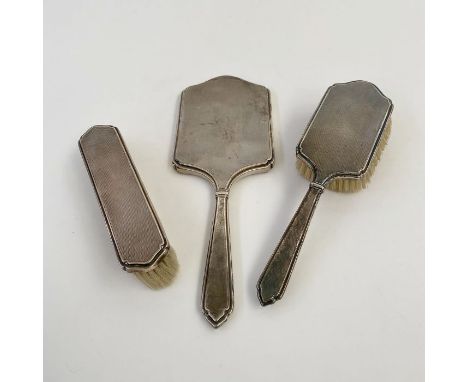 Victorian silver three-piece dressing set, engine turned including silver-backed mirror and two silver-backed brushes, London