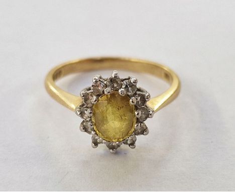 18ct gold, yellow stone and diamond cluster ring, the oval yellow stone surrounded by smaller diamonds&nbsp;