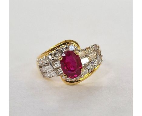 Gold metal, ruby and diamond set ring, set oval ruby, flanked by 12 baguette diamonds and twelve brilliant cut diamonds