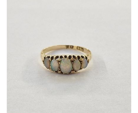 Gold-coloured metal and opal dress ring set five graduated opals, claw set (some wear to the setting)&nbsp;