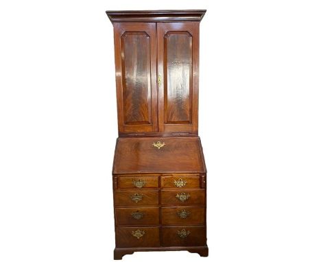 George III mahogany bureau bookcase, the top section with cavetto frieze, three adjustable shelves, pigeonholes and small dra