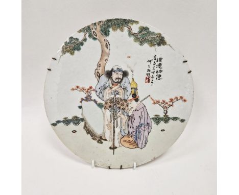 Chinese porcelain plaque, circular and painted with old man leaning on a gnarled peach stick with flautist kneeling and playi