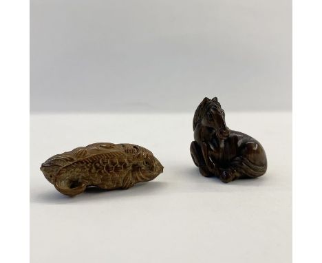 Japanese carved wood netsuke&nbsp;in the form of a seated foal, 4cm high and another&nbsp;in the form of a fish, 5cm long (2)