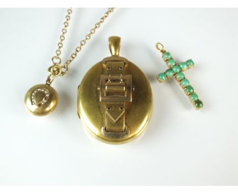 A Victorian oval locket, with buckle motif to the cover, not stamped, together with a turquoise set crucifix and a seed pearl