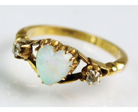 An 18ct gold opal and diamond ring, designed as a central heart shaped opal flanked to each side by an old cut diamond, ring 