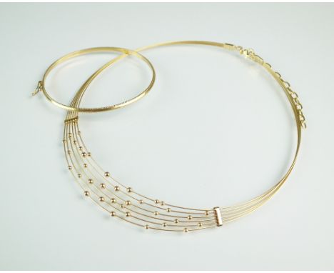 A 14ct gold tapering collarette with bead decoration, together with a 9ct gold hinged bangle, total weight 12.5g (2)