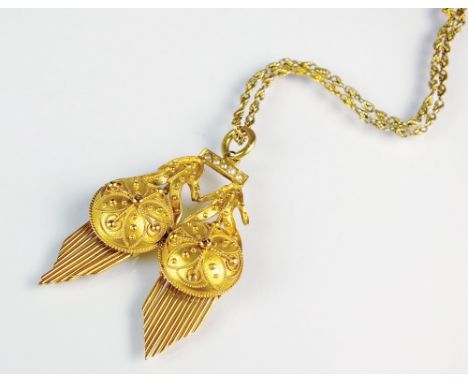 A yellow metal tassel pendant, designed as two circular bead work panels suspending graduated fringe tassels and mounted to s