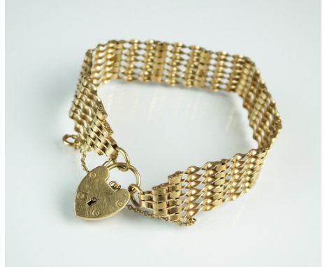A 9ct gold seven bar twisted gate link bracelet, with attached heart shaped padlock clasp, weight 20.7g