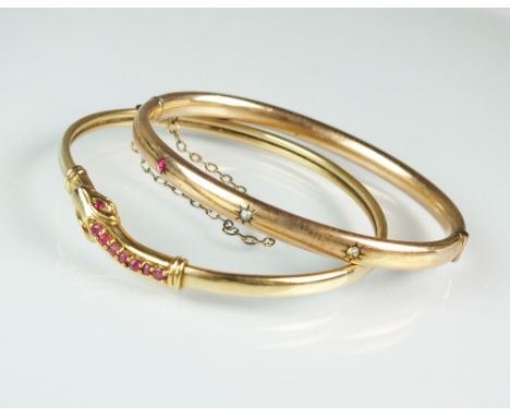 A 9ct gold ruby set snake bangle, weight 7.6g, together with a seed pearl and paste set bangle (2)