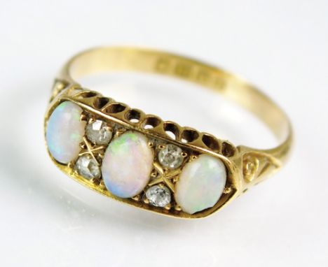 An early 20th century 18ct gold seven stone opal and diamond ring, designed as a row of three graduated oval cabochon opals i