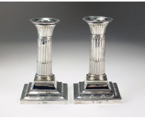 A pair of Victorian silver mounted candlesticks, William Hutton & Sons Ltd, London 1898, each with fluted column and raised o