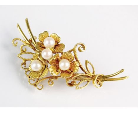 An 18ct gold pearl set floral spray brooch, designed as four floral clusters set to yellow gold scrolling leaf bar, hallmarke