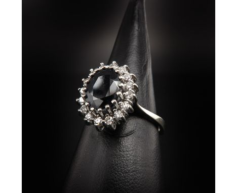 Set with 16 brilliant cut diamonds and 1 faceted Sapphire, ring size 17.5.