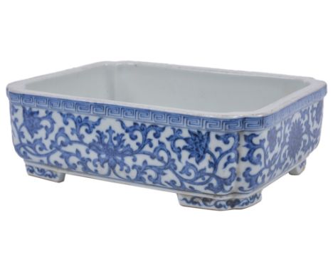 A Small Chinese Blue and White Planter:
Of rectangular shape with indented corners. Enamelled with flower scrolls and a key f