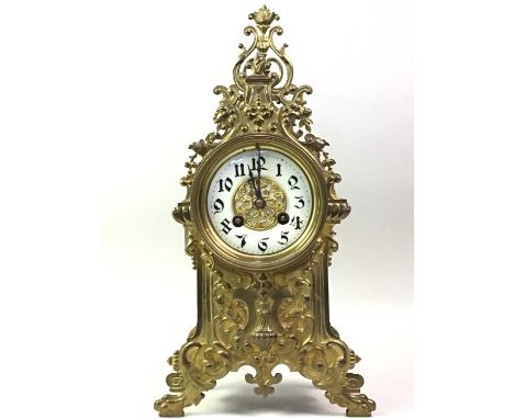 CONTINENTAL BRASS MANTEL CLOCK, the circular enamel face with Arabic numerals37cm high