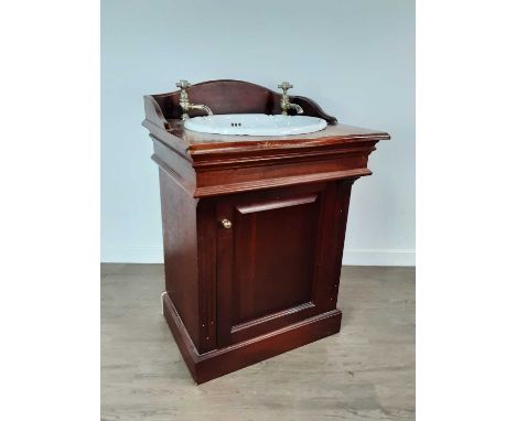 VICTORIAN STYLE SINK UNIT, 20TH CENTURY the mahogany effect unit inset with a shaped oval ceramic basin and with brass taps, 
