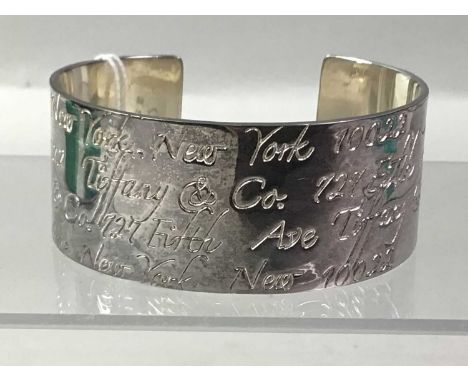 TIFFANY SILVER BANGLE, ALONG WITH A TIFFANY SILVER KEY RING the bangle from The Notes Collection, 1997Qty: 2