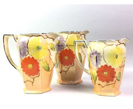 SET OF THREE ARTHUR WOOD GRADUATED WATER JUGS, ALONG WITH A PAIR OF ROBERT GORDON SERVING DISHES the jugs with stylised flowe