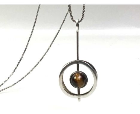 VINTAGE FINNISH PENDANT ON CHAIN, C.1970S set with a cabochon circular tiger's eye within an orbital surround, with anvil mar