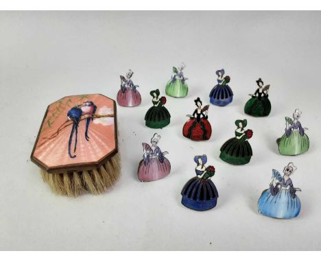 SET OF ELEVEN ART DECO STYLE ENAMELLED MENU PLACE NAME CARD HOLDERS, EARLY / MID 20TH CENTURY  possibly French, each modelled