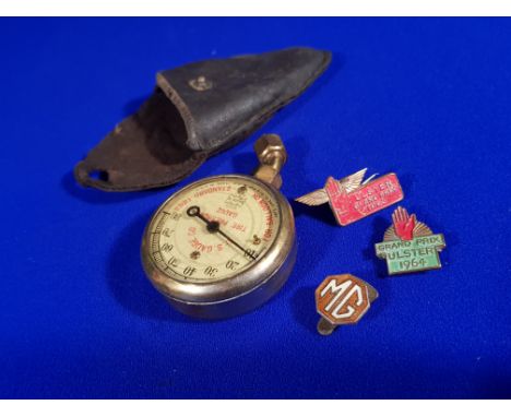 3 VINTAGE MOTORING BADGES & ANTIQUE AMERICAN TYRE PRESSURE GAUGE - ULSTER GRAND PRIX 1963, ULSTER GRAND PRIX 1964 & MG BADGE