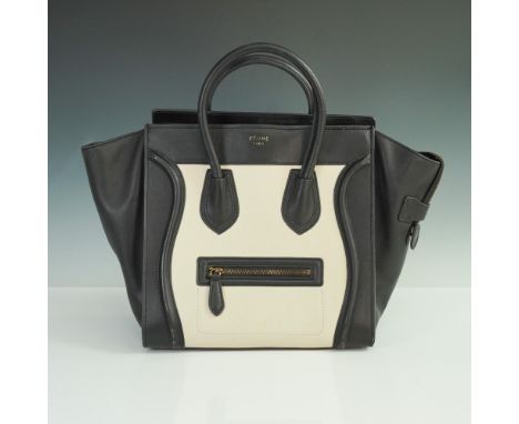 Celine Paris Mini Luggage Tote in smooth black and cream leather with rolled top handles, signature curved piping, and a fron