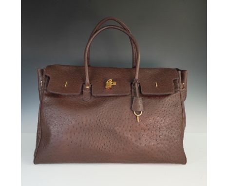 Luxurious brown handbag crafted from genuine ostrich leather, featuring signature quill patterning across the exterior. The b