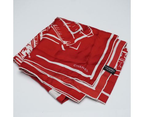 Striking red and white silk scarf by Chanel, featuring a dynamic cityscape motif with stylized architectural landmarks radiat