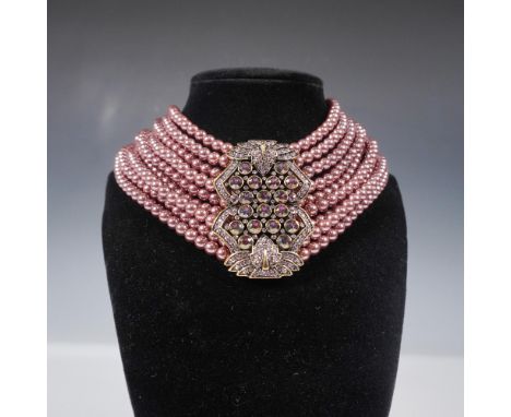 This Heidi Daus 9-strand choker necklace showcases luxurious mauve-hued faux pearls, elegantly layered for a bold and opulent