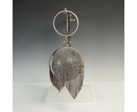Dramatic rhinestone-encrusted sphere minaudiere evening bag featuring a draped chain fringe design and a rhinestone-studded r