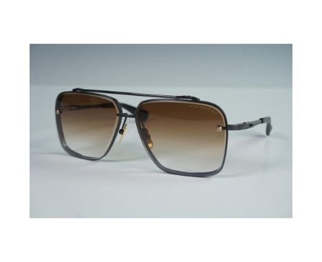 These high performance Dita Mach Six sunglasses showcase a bold square silhouette with black titanium frames, gold-tone detai