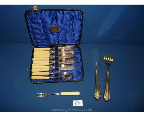 A pair of plated fish eaters and fish servers plus a pickle fork.