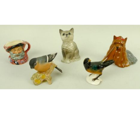 A group of ceramic figurines, 20th century, comprising a Royal Doulton grey seated cat, 10cm, a miniature character jug, Fals