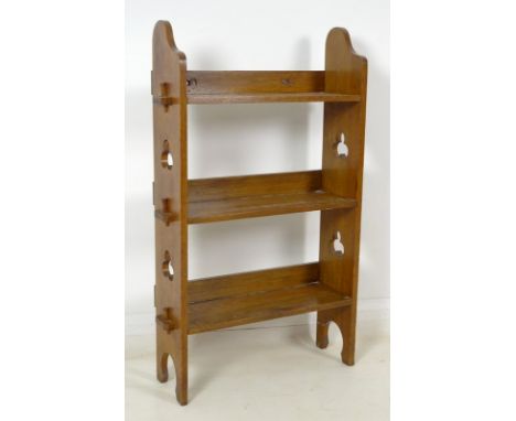 An oak three shelf freestanding bookcase, circa 1960's, with pierced and carved ends with trefoil decoration, 55 by 19 by 98c