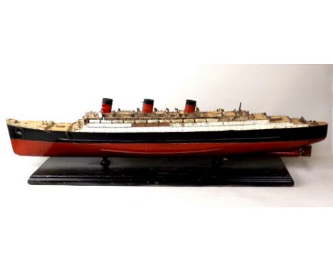 A painted wooden model of the Queen Mary, mid 20th century, with burgundy and black hull, on a wooden stand, 16 by 25 by 120c