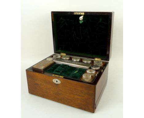 A 19th century oak vanity case, fully fitted interior to include nine glass bottles with covers, a fold-down section with mir