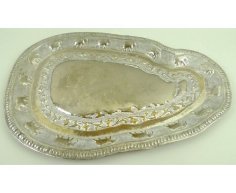 An unmarked Ceylon silver metal tray, in the shape of Sri Lanka, impressed to the border with seventeen elephants and bands o