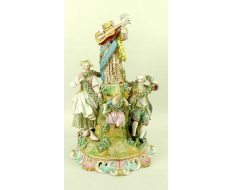 A 19th century porcelain centrepiece figural group, comprising five figures amongst rocks, with a woman playing a guitar abov