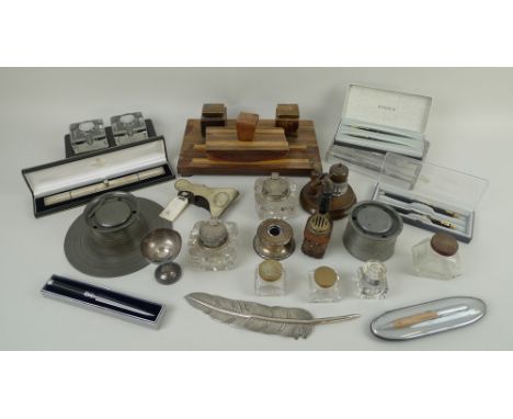 A collection of desk items, including a silver plated letter opener, a variety of inkwells in pewter, glass, silver and wood,