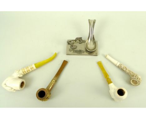 A collection of four pipes, including a Chinese bone example carved with a dragons amongst stylised clouds, 13.5cm, together 