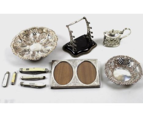 A group of silver items, comprising a photograph frame with two oval sections, a bon-bon dish, a smaller dish, a silver and t